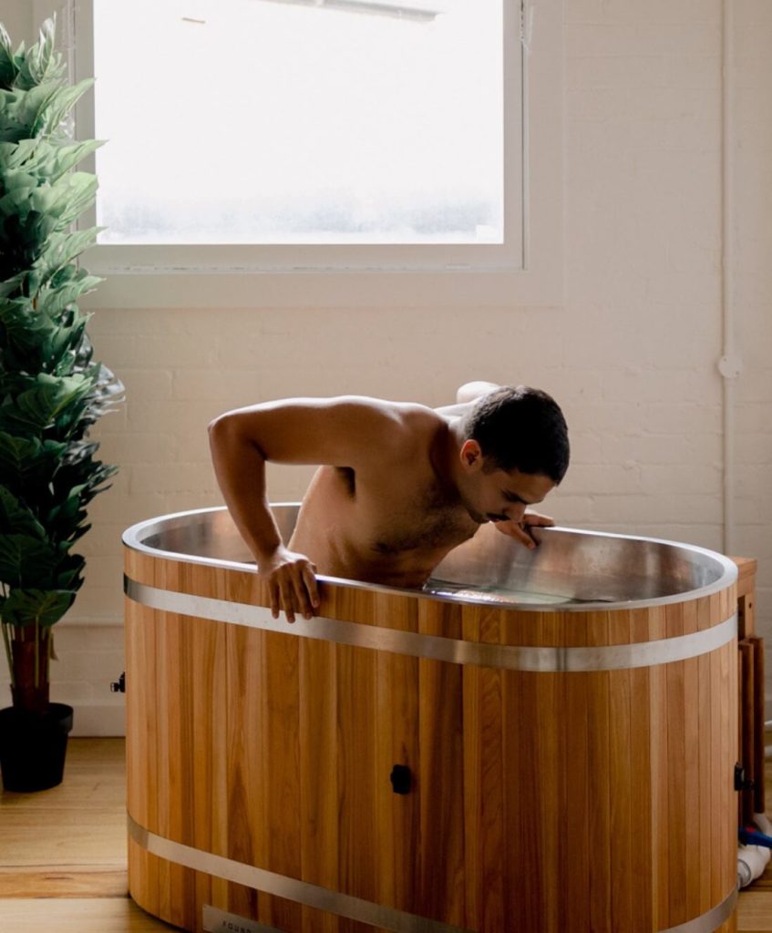 man immersing himself in cold plunge